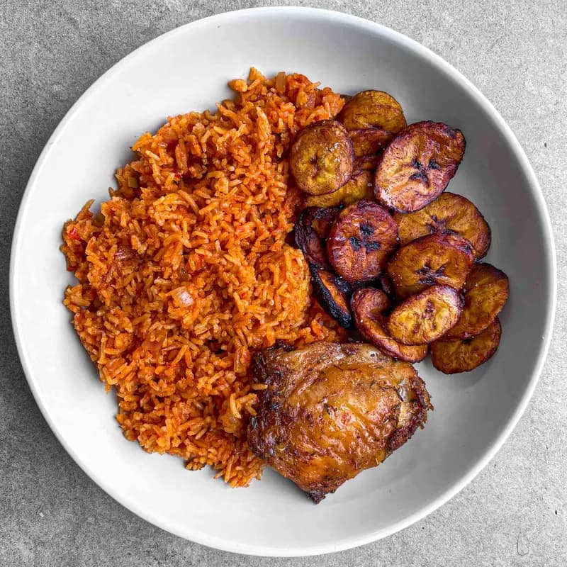 Jollof rice with fried plantain and chicken, overhead