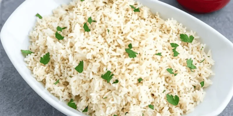 Fluffy steamed white rice in a white dish